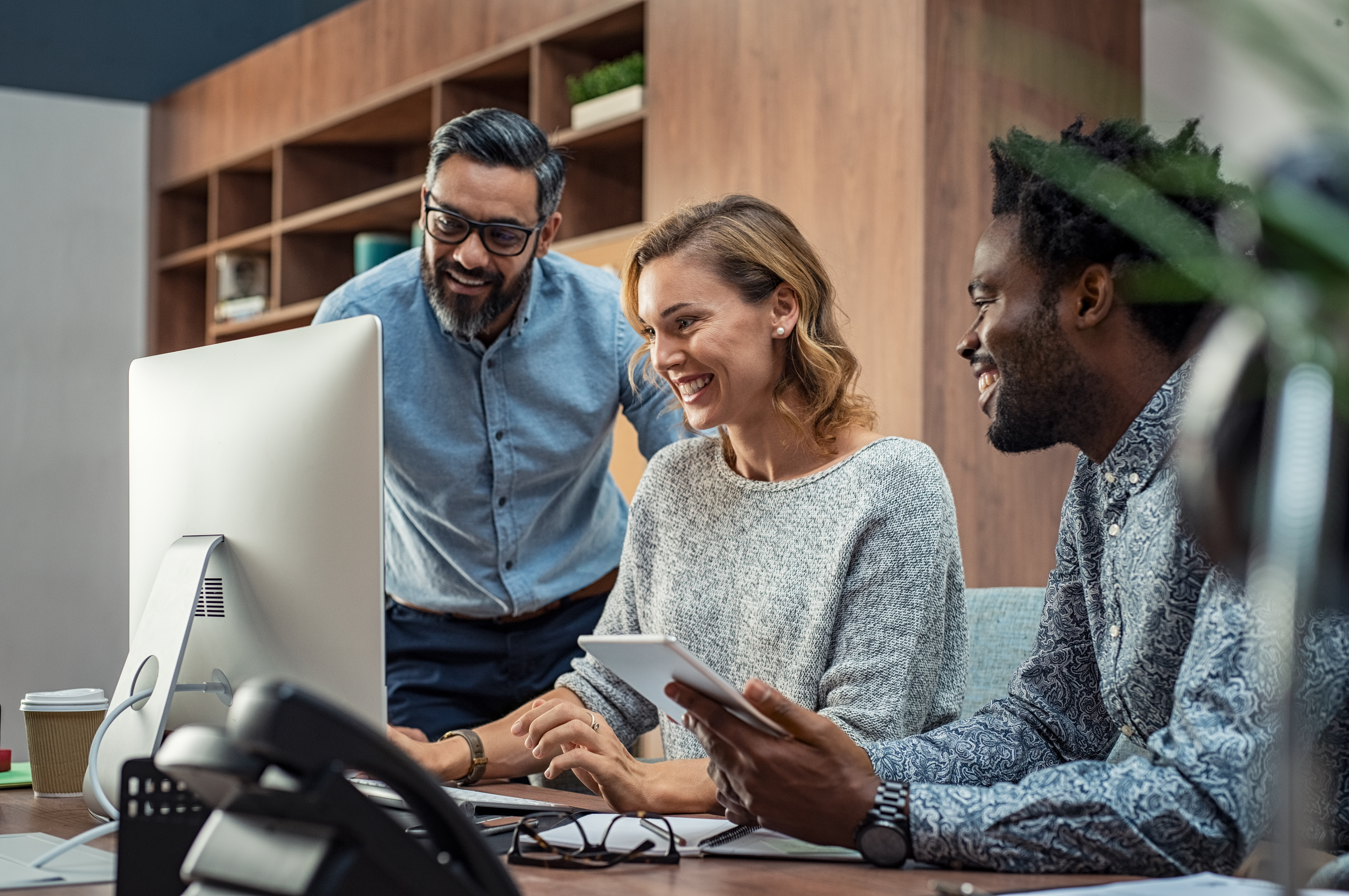 team gathered around a computer